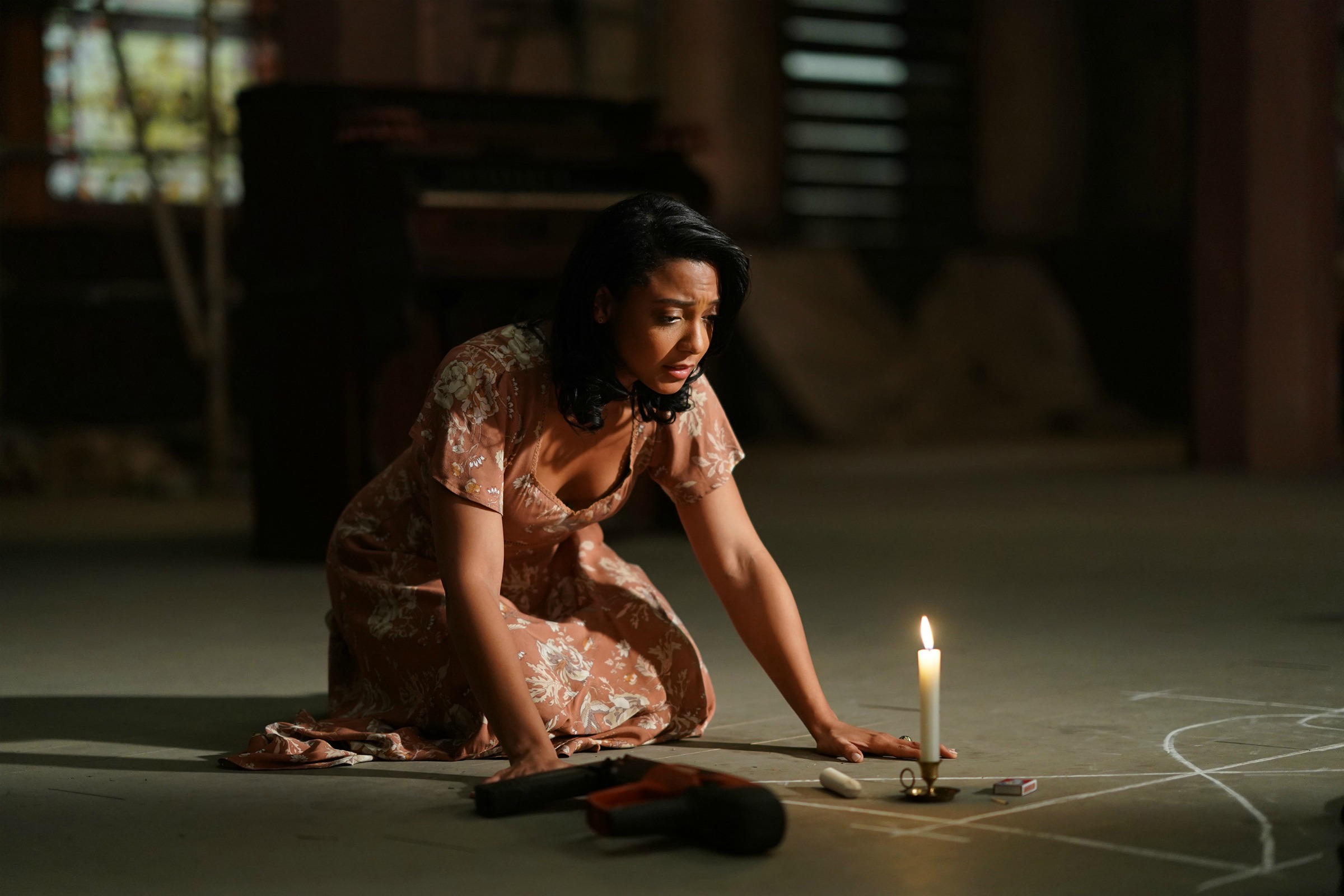 Evita watches over the candle that is acting as a timer for the portal to the Darkforce Dimension inside the abandoned church.